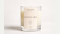 a glass candle with a label on it