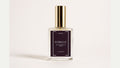 a bottle of perfume with a gold cap