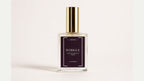 a bottle of perfume with a gold cap