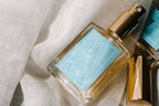 a bottle of perfume on a white fabric