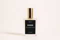 a bottle of perfume with a gold cap